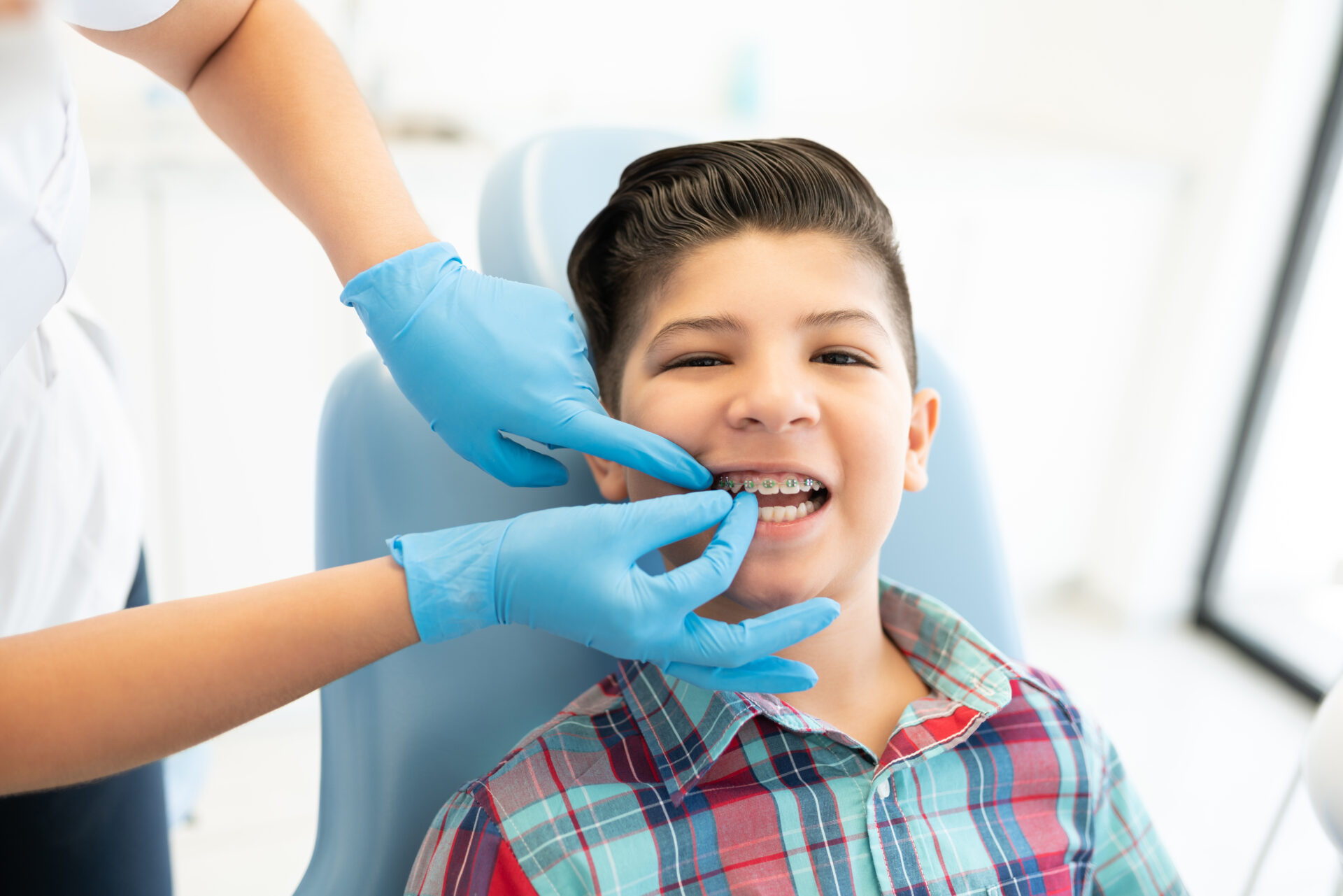 Smiling boy in a dental chair having his teeth checked